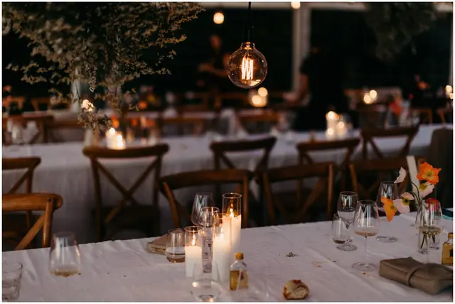 Marty & Nicola at Byron View Farm: Candles glow on the reception tables after dark.
