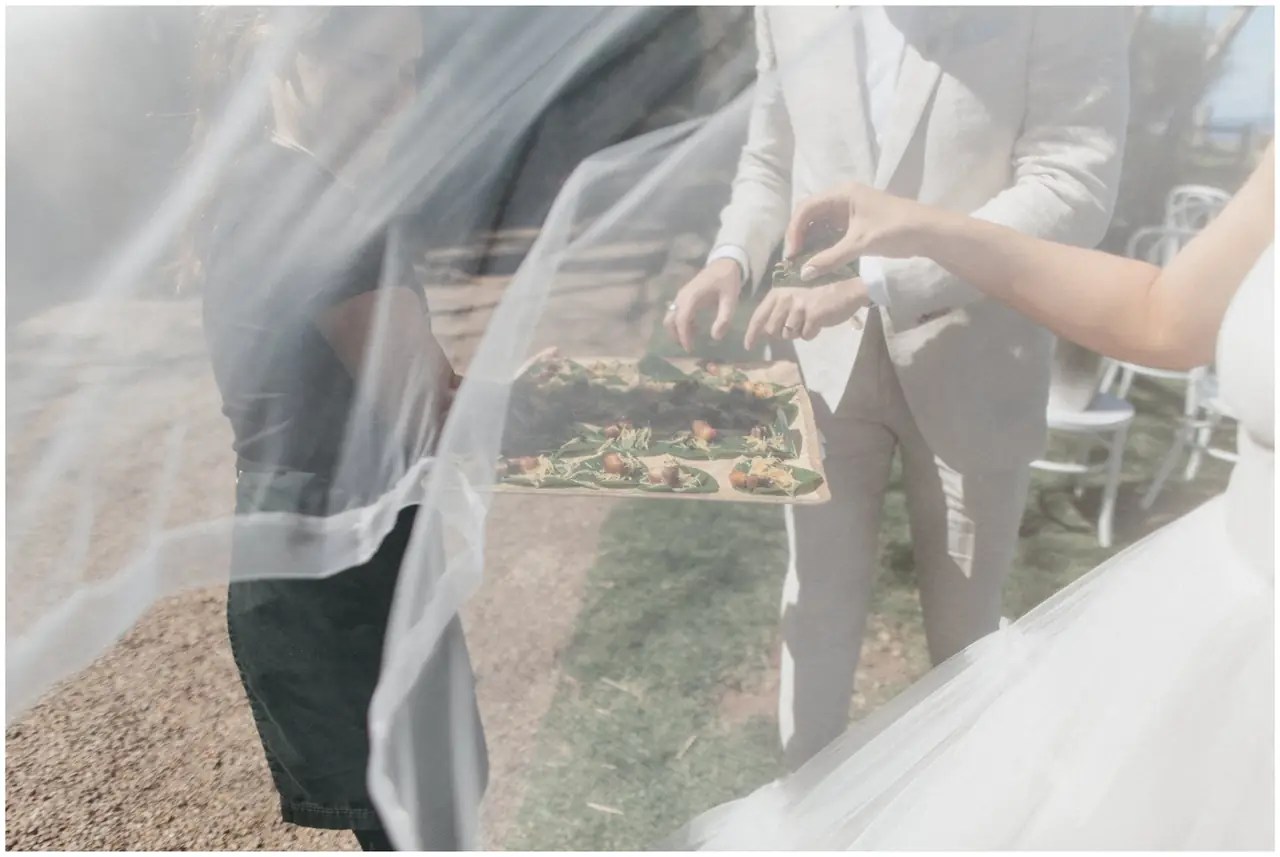 Marty & Nicola at Byron View Farm: A close view through the bride’s veil as it is adjusted.