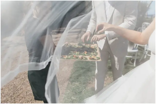 Marty & Nicola at Byron View Farm: A close view through the bride’s veil as it is adjusted.