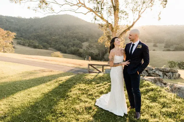 Luke & Cara at Cowbell Creek: The couple stand beneath a tree in the evening light.