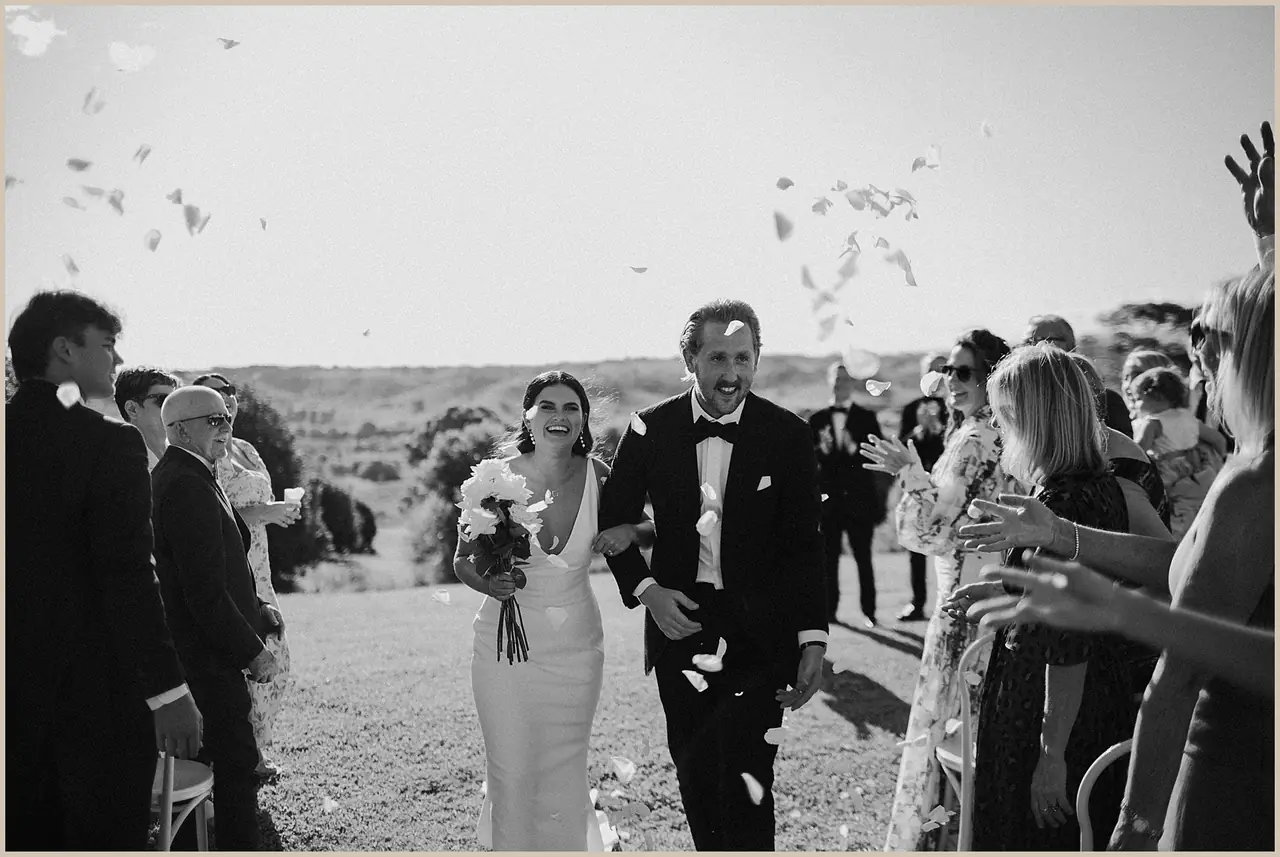 Jess & Rich at The Orchard Estate: The newlyweds walk through cheering guests and falling confetti.