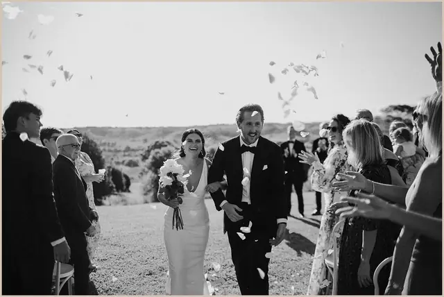 Jess & Rich at The Orchard Estate: The newlyweds walk through cheering guests and falling confetti.
