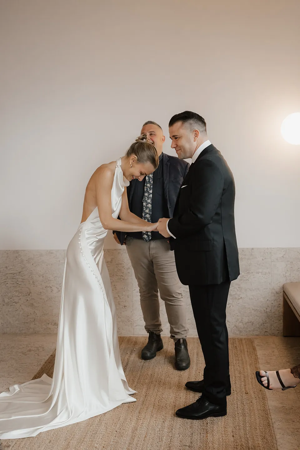 Clare and Matt exchanging rings in their suite with celebrant Josh Withers.