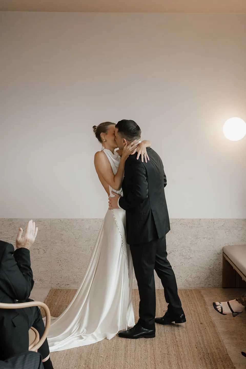 Clare and Matt kissing at the end of their ceremony in The Calile suite.