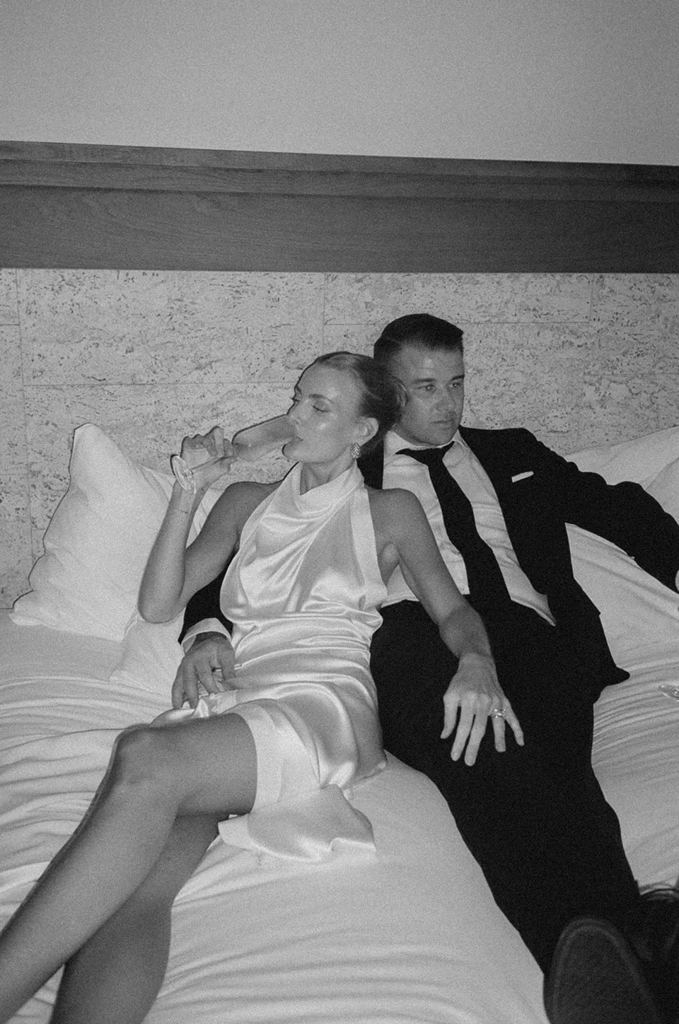 Black-and-white photograph of Clare and Matt relaxing together on a sofa.